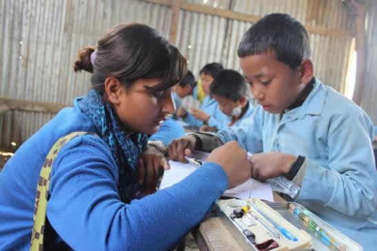 Nija, one of the TfN fellows, supporting a student in her class