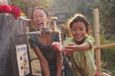 Children in Tosramkhola celebrate having access to clean water in their community