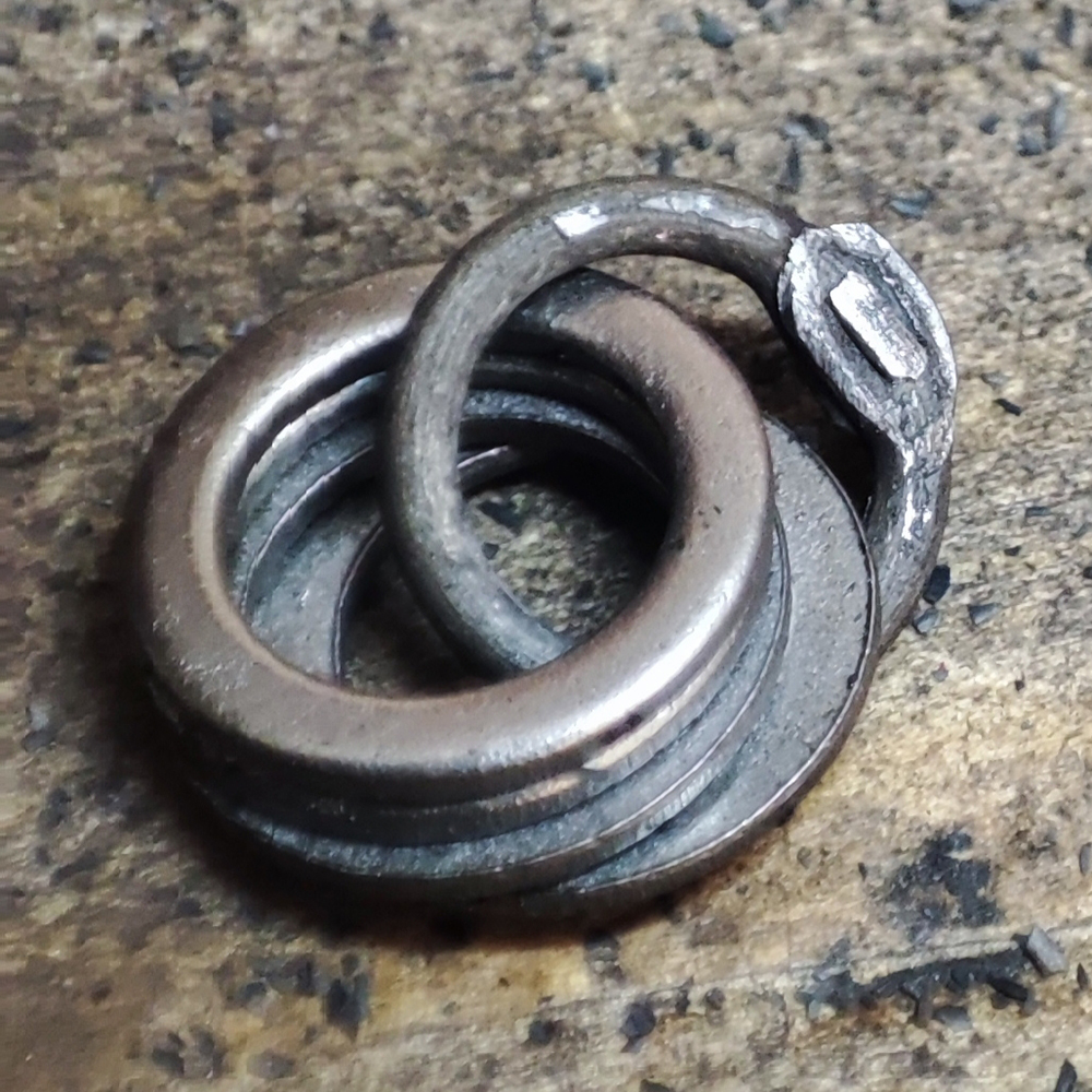 A wedge riveted ring linked to four solid rings